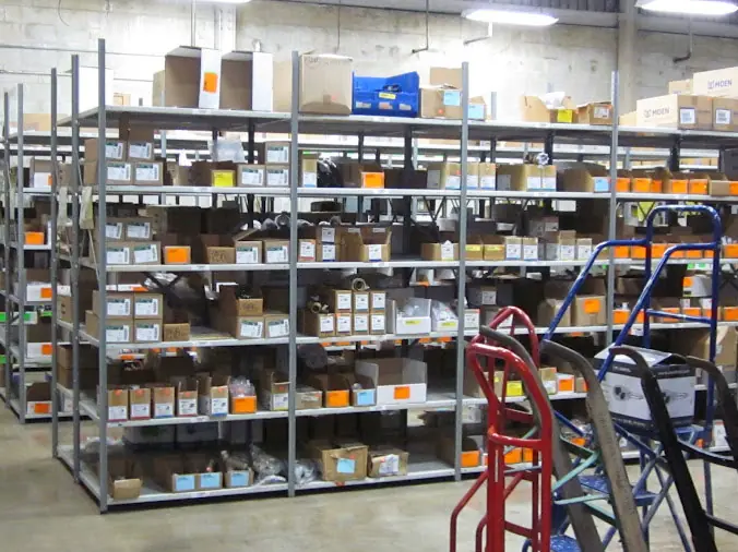 Warehouse shelves stocked with professional plumbing supplies at Huges Supply Daytona
